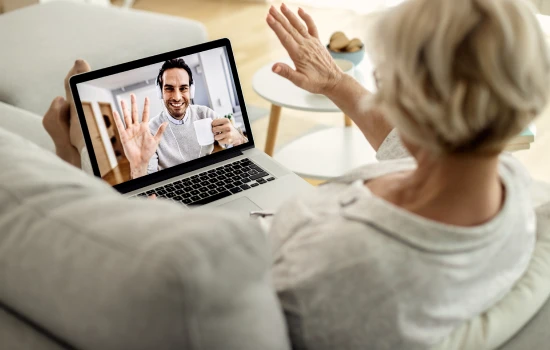senior-woman-using-laptop-doctor-consult-for-travel-holiday-cancellation-certificate