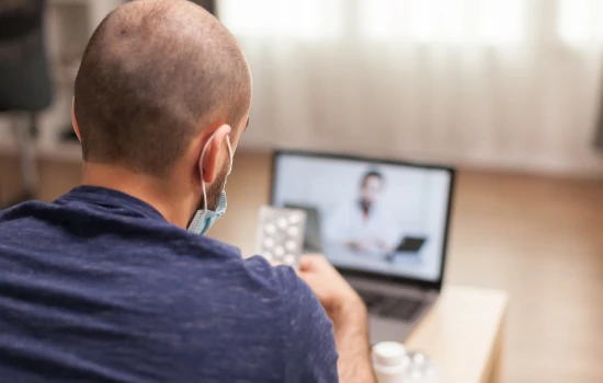 travelling-with-medication-man-in-video-call-with-doctor