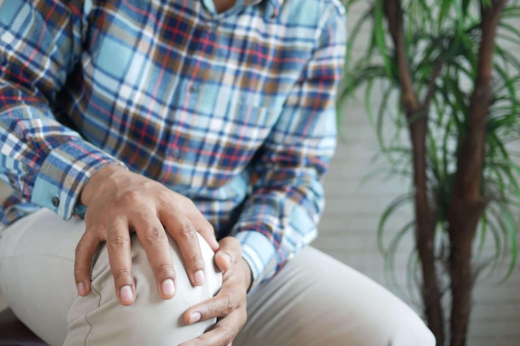 Man holding his knee
